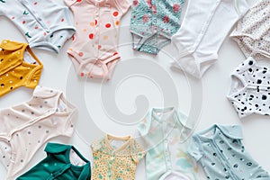 onesies with different patterns and colors spread on a white background