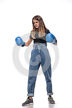 Ð¡onfident girl  in blue boxing gloves focused to win, isolated