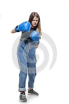 Ð¡onfident girl  in blue boxing gloves focused to win, isolated