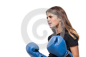 Ð¡onfident girl  in blue boxing gloves focused to win, isolated
