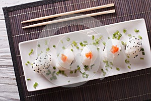 Onigiri rice balls close-up on a plate. Horizontal top view