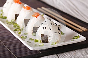 Onigiri rice balls with salmon and sesame close-up. horizontal