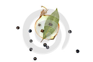 Onion with bay leaf, juniper berries and cloves photo