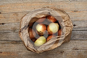 Onion bulbs in a kraft paper bag