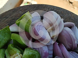 Onion and Capsicum Slices isolated on Wood Background