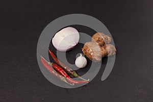 Onion, chilli, one clave garlic and ginger, all are ingredients of tasty and spicy cooking food. photo