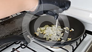 Onion and garlic fried on frying pan, in kitchen.  Grilled vegetables in olive oil