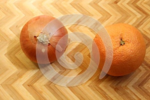 Onion and Orange on bamboo cutting board, zig-zag background
