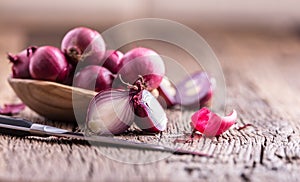 Onion. Red onions on very old oak wood board