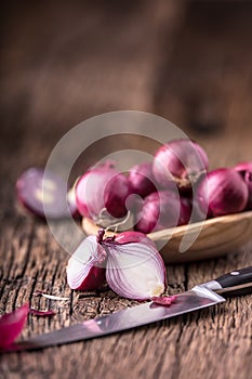 Onion. Red onions on very old oak wood board