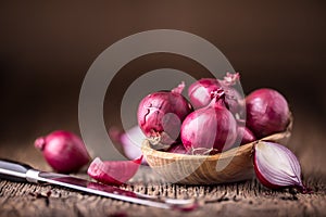 Onion. Red onions on very old oak wood board
