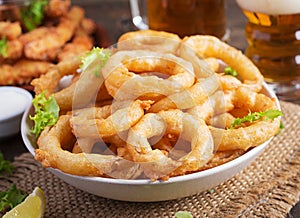 Onion rings in batter with sauce and cheese sticks. Beer snacks.