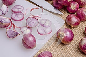 onion or shallot and knife put on the cutting board group