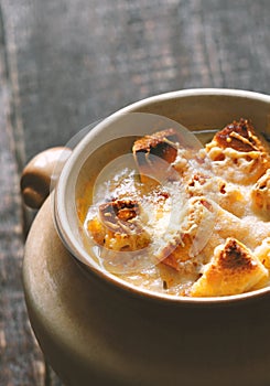 Onion soup in the ceramic pot vertical