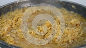 Onion stewing in a pan