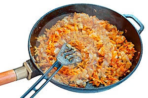 Onions and carrots in the pan, roast for soup, saute the vegetables for the soup in the pan