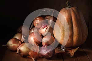 Onions in a cloth bag and pumpkin