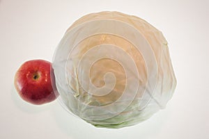 Onions in a paper bag and an apple, white background, fruit and freshness, aphorisms written on paper photo