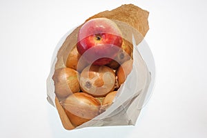 Onions in a paper bag and an apple, white background, fruit and freshness, aphorisms written on paper