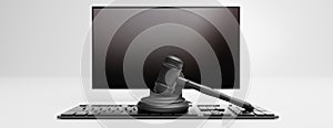 Online auction, cyber crime, law and technology. Judge gavel on black computer. 3d illustration