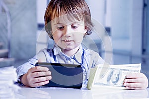 Online banking concept. Portrait of happe business child girl wi