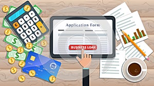 Online business loan or lending concept. Home mortgage. Flat tablet with loan application form and hand click button on desk
