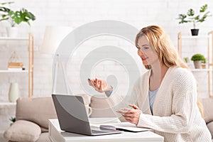 Online business meeting. Woman communicates with client in laptop photo