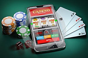 Online casino and gambling concept. Slot machine on smartphone screen, cards, dice and poker chips