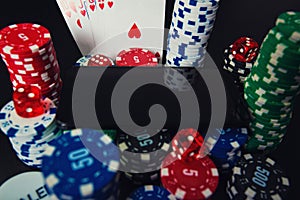 Online casino gambling concept. Smartphone blank screen on chips stack, royal flush poker cards combination and red dices and