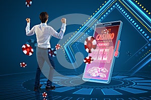 Online casino and gaming, gambling on device concept. Happy european businessman and smartphone with creative slot machine and