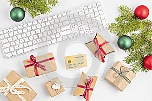 Online christmas shopping concept with gift boxes, keyboard and golden credit card