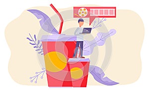 Online cinema, internet streaming. Man holding laptop, standing on big paper cup with drink