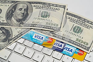 Online Commerce, Ecommerce, credit and debit cards with dollars and a keyboard.