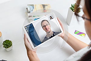 Online conference concept. Woman using tablet to make video call with business partner