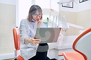 Online consultation, doctor help in clinic using laptop.