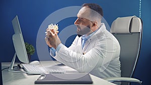 Online consultation in doctors office. Doctor demonstrates the departments of the spine vertebrae, hernia and it`s injuries