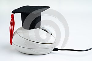 Online course, e-learning or internet study via website and online teaching concept, graduation hat on computer mouse on white