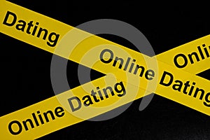 Online dating alert, caution and warning concept. Yellow barricade tape with word