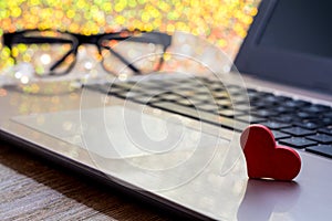 Online Dating concept with laptop red heart shape and wooden words