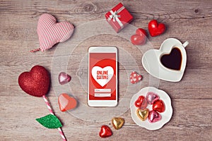 Online dating concept with smartphone mock up and heart chocolates. Valentine's day romantic celebration.