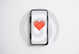 Online dating concept. Smartphone with red heart on the screen