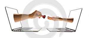 online dating concept two hands stick out of laptop screen