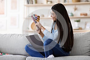 Online Design Courses. Asian Woman Holding Colour Swatch And Using Laptop At Home