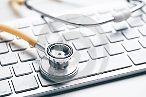 Online doctor concept with stethoscope on keyboard