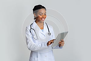 Online Doctor Consultation. Portrait Of Black Female Therapist Using Digital Tablet