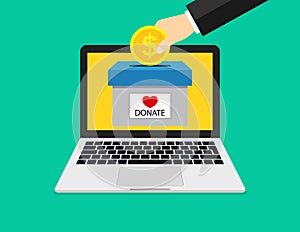 Online donate in computer. Hand holding dollar coin for charity in laptop screen. Online internet fundraising for donation. Give