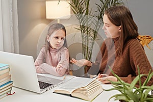 Online education for children. Remote learning with laptops. Schoolwork assistance using computers. Tired little girl with teacher