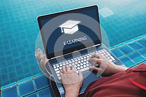 Online education, e-learning and e-book concept. a man using computer laptop for education on weekend holiday at poolside in summe