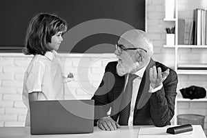 Online education and learning. Back to school. Teacher and pupil with laptop. Schoolboy in classroom.