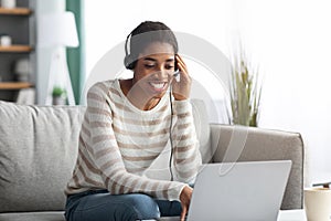 Online Education. Smiling Black Woman In Headset Study With Laptop At Home